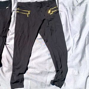 Black slacks with gold zippers